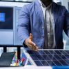 Engineer explaining a solar panel system in a lab with digital monitoring screens