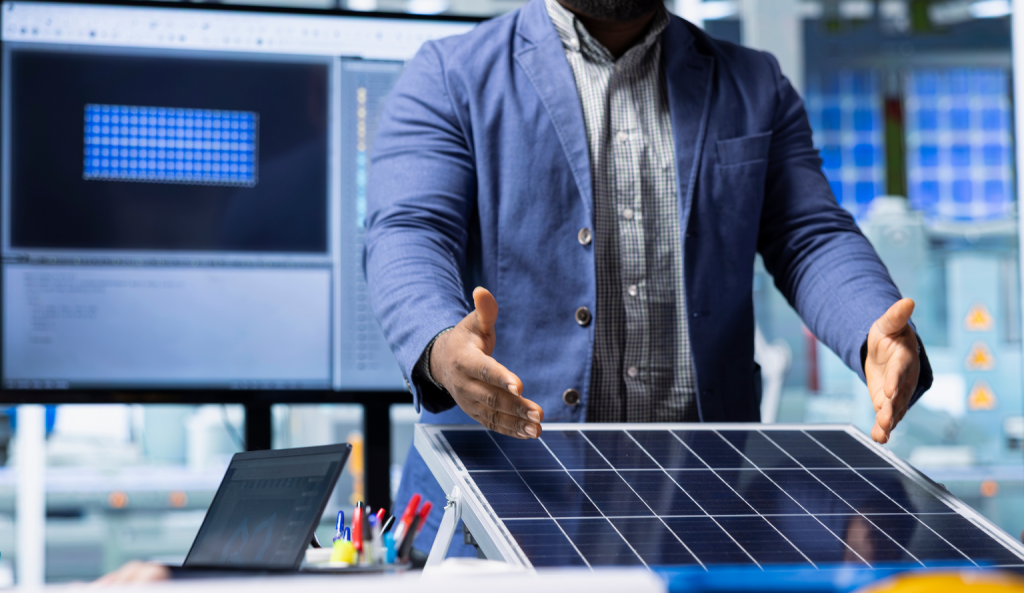 Engineer explaining a solar panel system in a lab with digital monitoring screens